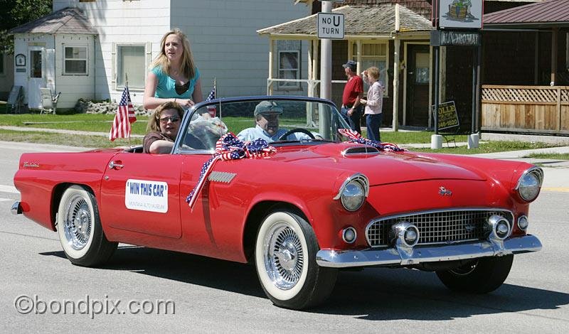 Deer-Lodge-Parade_14694.jpg - A red 1955 Thunderbird, this years 'Win a Classic Car' raffle for the Montana Auto Museum is driven along Main Street during the Territorial Days Parade in Deer Lodge Montana, June 14th 2008