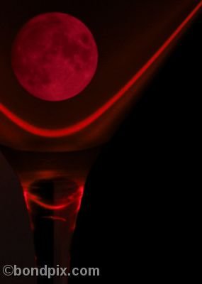 Red moon in a glass lit by laser