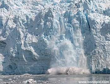 Calving ice falls from the Hubbard Glacier in Yakutat bay, Alaska