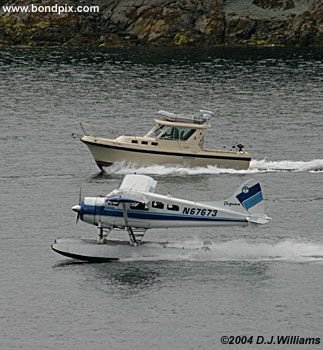 Floatplane races a boat in Ketchikan Alaska