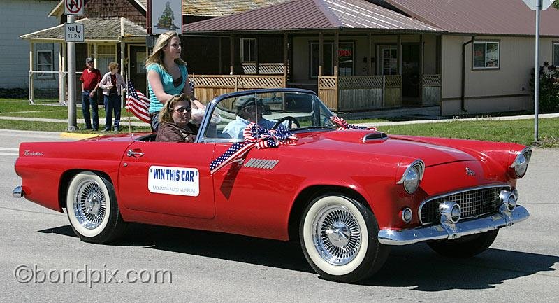 Deer-Lodge-Parade_14695.jpg - A red 1955 Thunderbird, this years 'Win a Classic Car' raffle for the Montana Auto Museum is driven along Main Street during the Territorial Days Parade in Deer Lodge Montana, June 14th 2008