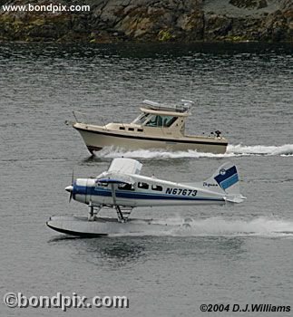 Floatplane races a boat in Ketchikan Alaska